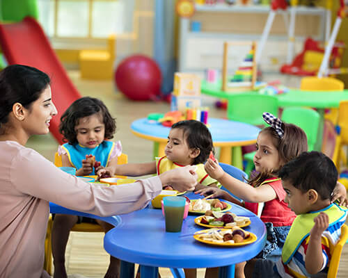 Teacher caring for children in daycare center